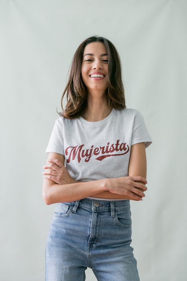 Photo of young woman in white t-shirt that reads The Mujerista