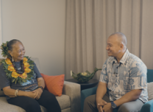 Two people  (one women, one man) together in conversation 