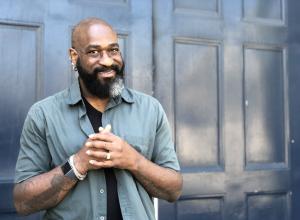 Photo of Charles Chip McNeal, a Black man in a blue button shirt